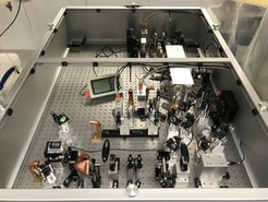 Photograph of the breadboard set-up of the 1550 nm pre-stabilized laser source for the ETPathfinder in the labs at AEI Hannover.