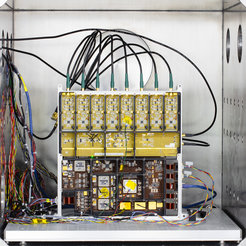 A sophisticated electrical circuit box with numerous different colored cables.